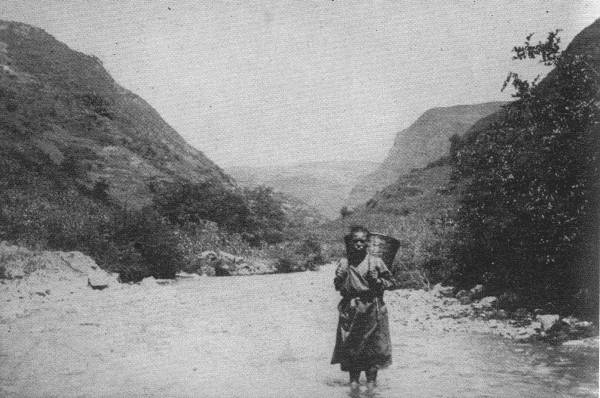 A LONELY TRAVELER

This picture was taken far out in untraveled China Far West. For days
you meet no sign of human habitation, and woe betide you if the river
rises!