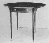 Pembroke tables were made by Hepplewhite. This is a fine
example and shows characteristic inlay and the legs sloping on the
inside edge only. The flaps fold down and make a small oblong table.