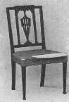 The upholstery of this Sheraton chair is fastened on with
brass-headed tacks placed in festoons.