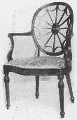 The wheel back design was often used by Adam. The arms,
the curve of the seat and carving, the tapering reeded legs, and the
angle of the back legs should all be noticed.