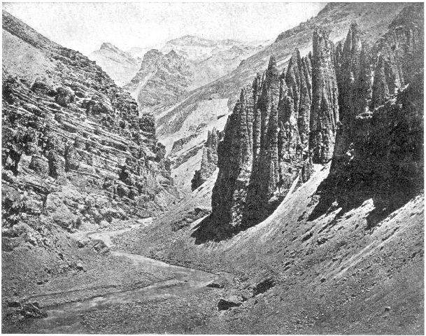 Mountain gorge, Himalayas, India. Note the difference
in the slope of the eroded rocks and the effect of erosion upon them;
also the talus slopes at the base of the cliffs which the torrent is
cutting away. On the left of the foreground there is a little bench
showing a recent higher line of the water.