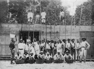 GROUP OF WORKERS ON CACAO ESTATE.
Some are standing on the Drying Platform, which is the roof of the Fermentary.