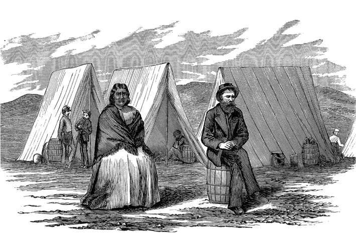 Sitting on up-ended barrels
among tents.