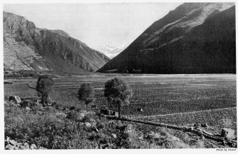 Fig. 43&mdash;The floor of the Urubamba Valley from Tarai. The
work of the glaciers was not confined to the lofty situations. Mountain
débris was delivered to all the streams, many of which aggraded their
floors to a depth of several hundred feet, thus increasing the extent of
arable soil at elevations where a less rigorous climate permits the
production of crops and encourages intensive cultivation.