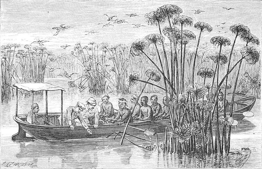 Die Expeditionsteilnehmer
  sitzen in einem Ruderboot auf einem Fluss