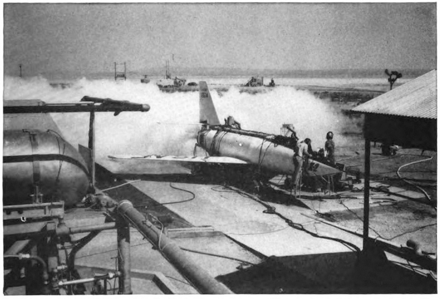 A plane on the ground with its engine running and steam billowing out around it