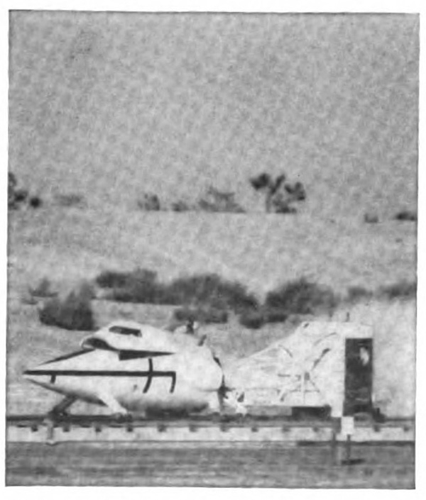 A plane on the ground with a canopy trailing behind it