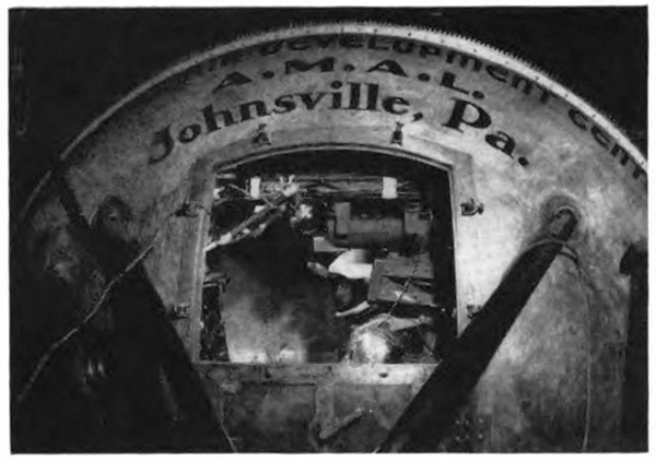 Image of a curbed metal object saying 'A.M.A.L. Johnsville, Pa.'