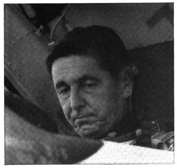 Close-up of a man with a serious expression on his face, eyes looking down