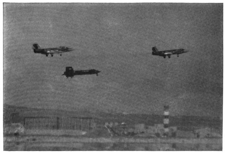 Three planes in the air with their landing gear visible